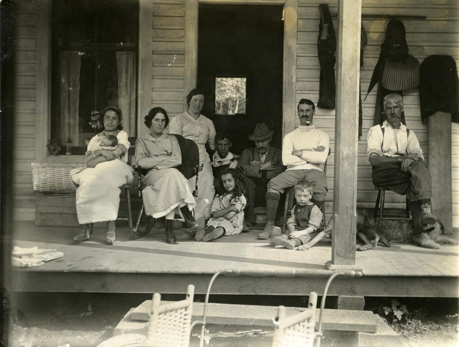 Members of the Sylvester family sitting on their porch