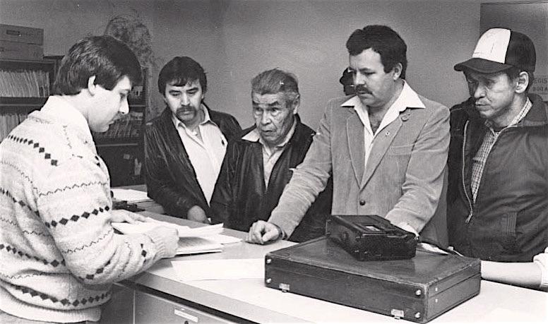 A Smithers court clerk receives the writ and statement of claim from the Gitxsan Wet'suwet'en Tribal Council in 1984. L-R Misilos, Delgamuukw, Neil Sterritt Gisdaywa.