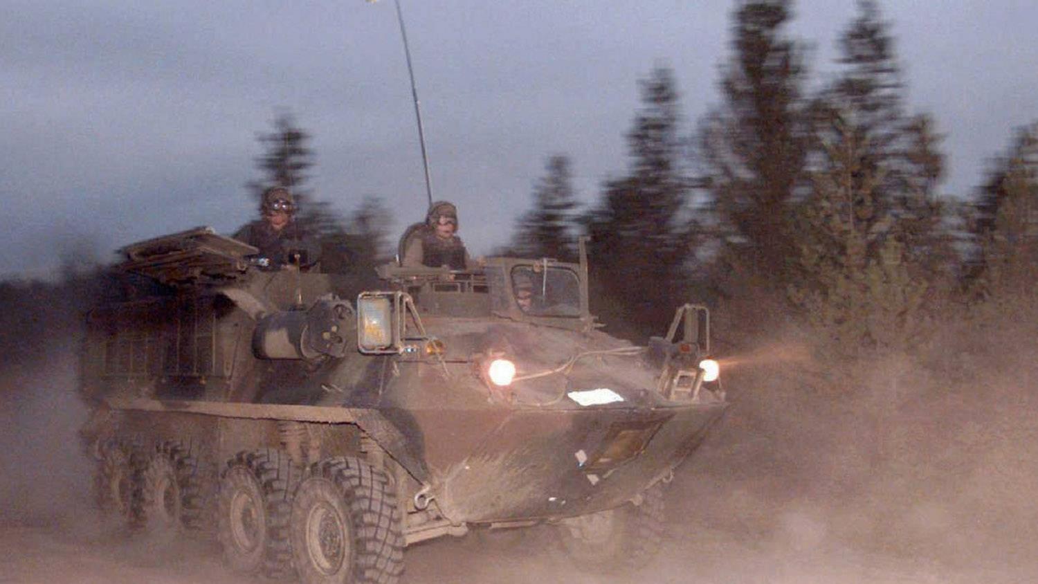 One of four military vehicles race past an RCMP checkpoint about 20 kilometres from the aboriginal camp at Gustafsen Lake, B.C., responding to what police said was increased aggression by the rebels toward the RCMP.