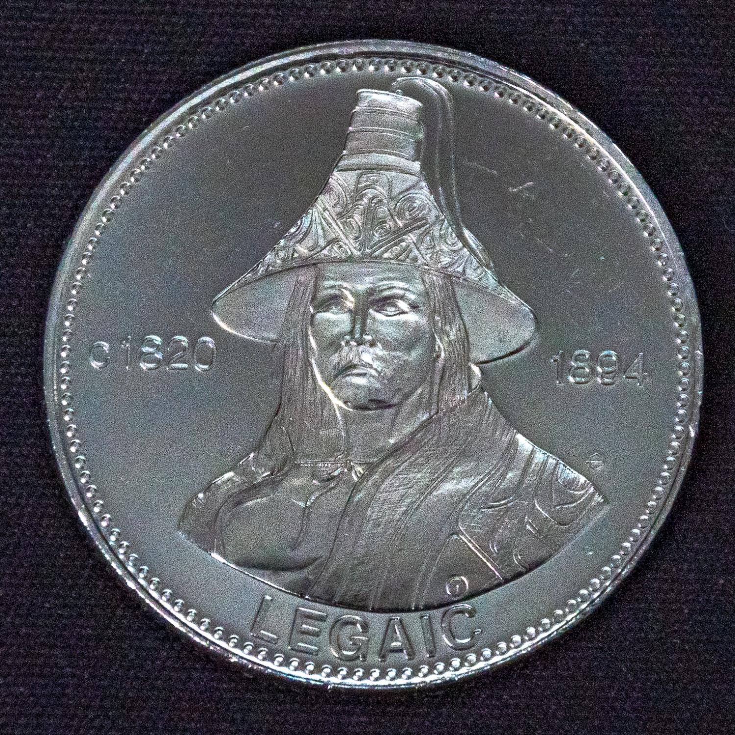 A coin with Chief Legaic engraved on the front. On it says c 1820 1894, LEGAIC