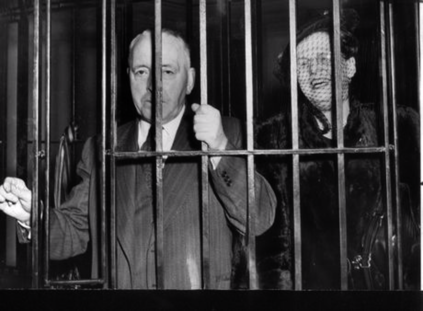 Maisie is on the right and her husband Tom on the left. That’s exactly how the caption identified them on April 11, 1955. The two were arrested for smashing a police padlock on the headquarters of a bootlegger client of Tom’s.