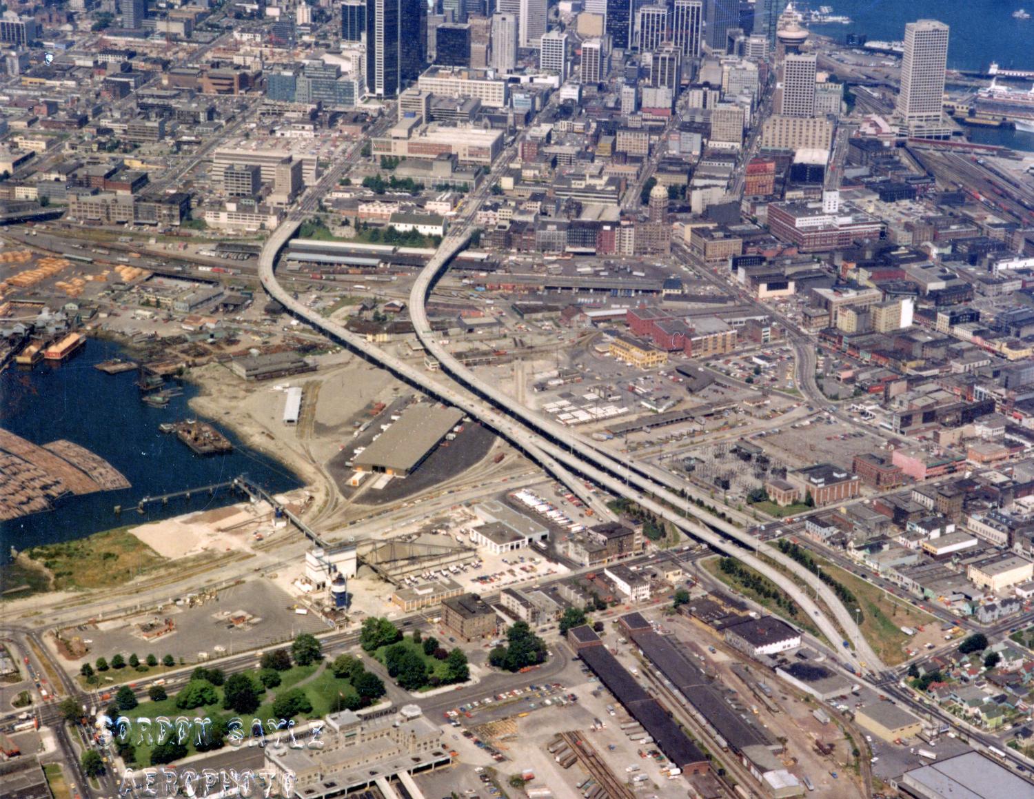 Aerial view of Strathcona to Downtown, with Georgia Viaduct, False Creek, Canadian Central Station and Canadian Western Cooperage sawmill.