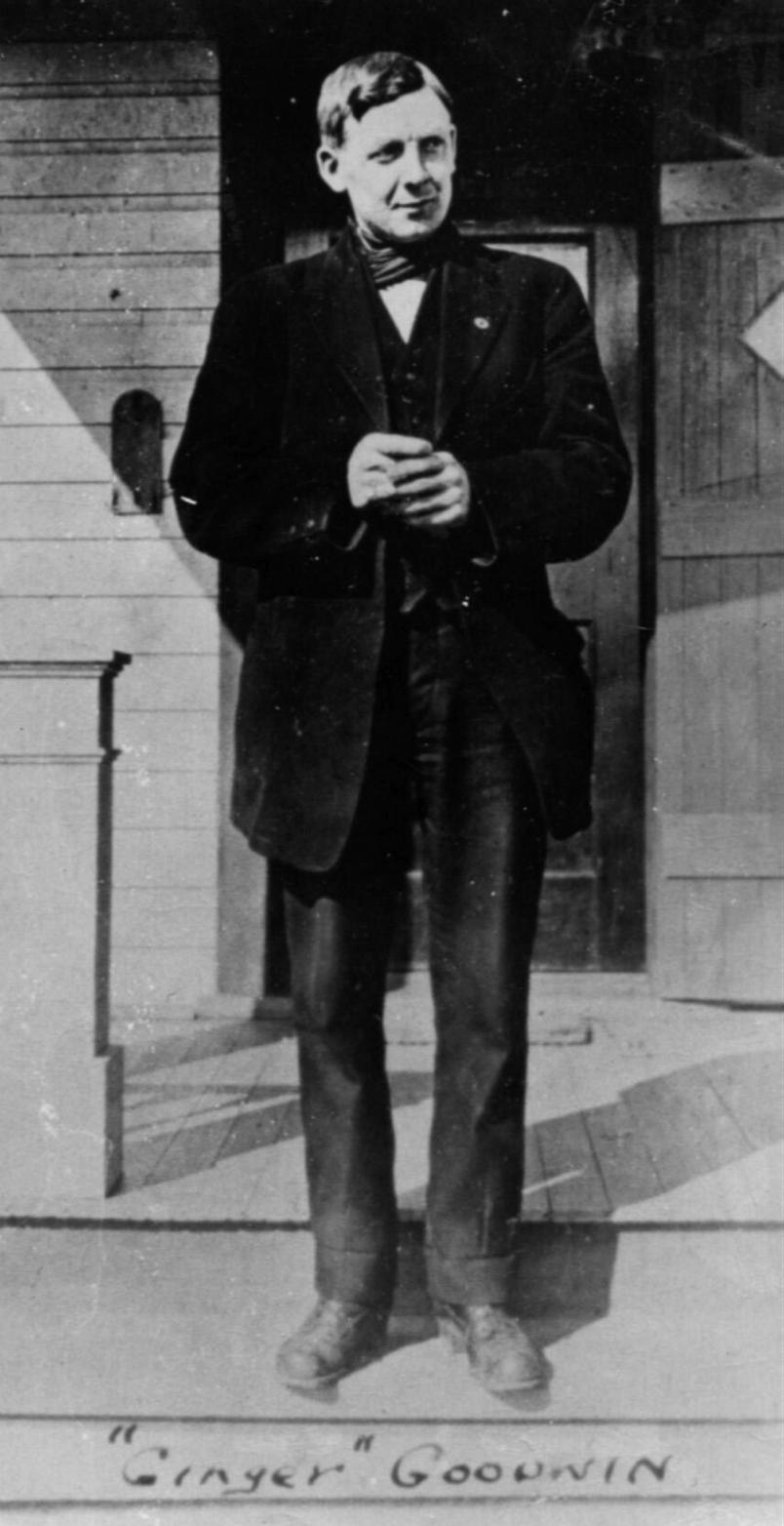 Ginger Goodwin standing with hands clasped in an undated photo.
