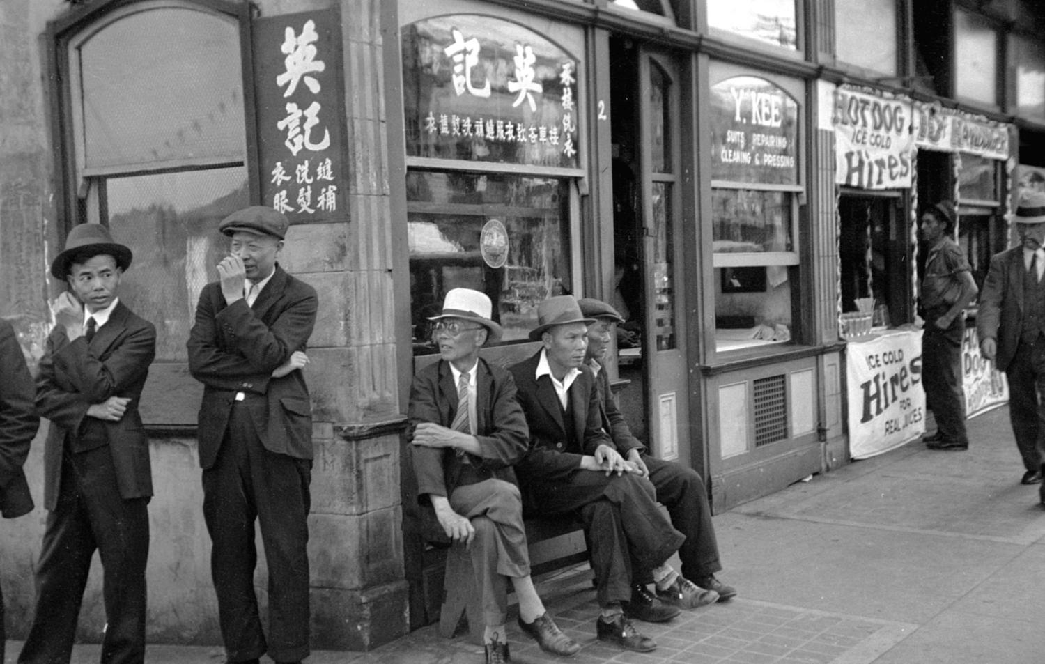 Chinese men hanging out outside a Chinese-owned business in 1936.
