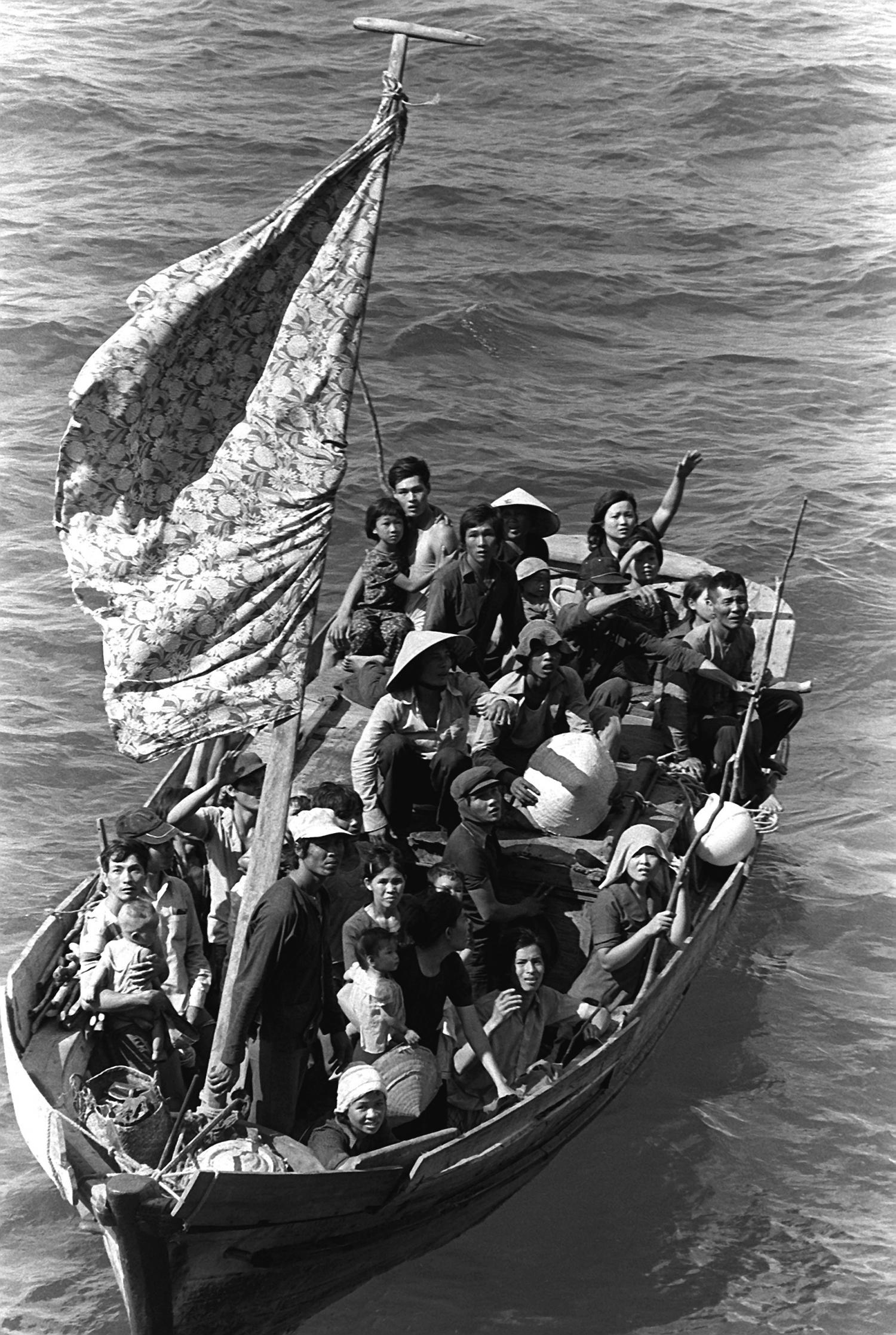 35 Vietnamese refugees wait to be taken aboard the amphibious command ship USS BLUE RIDGE (LCC-19). They are being rescued from a 35 foot fishing boat 350 miles northeast of Cam Ranh Bay, Vietnam, after spending eight days at sea