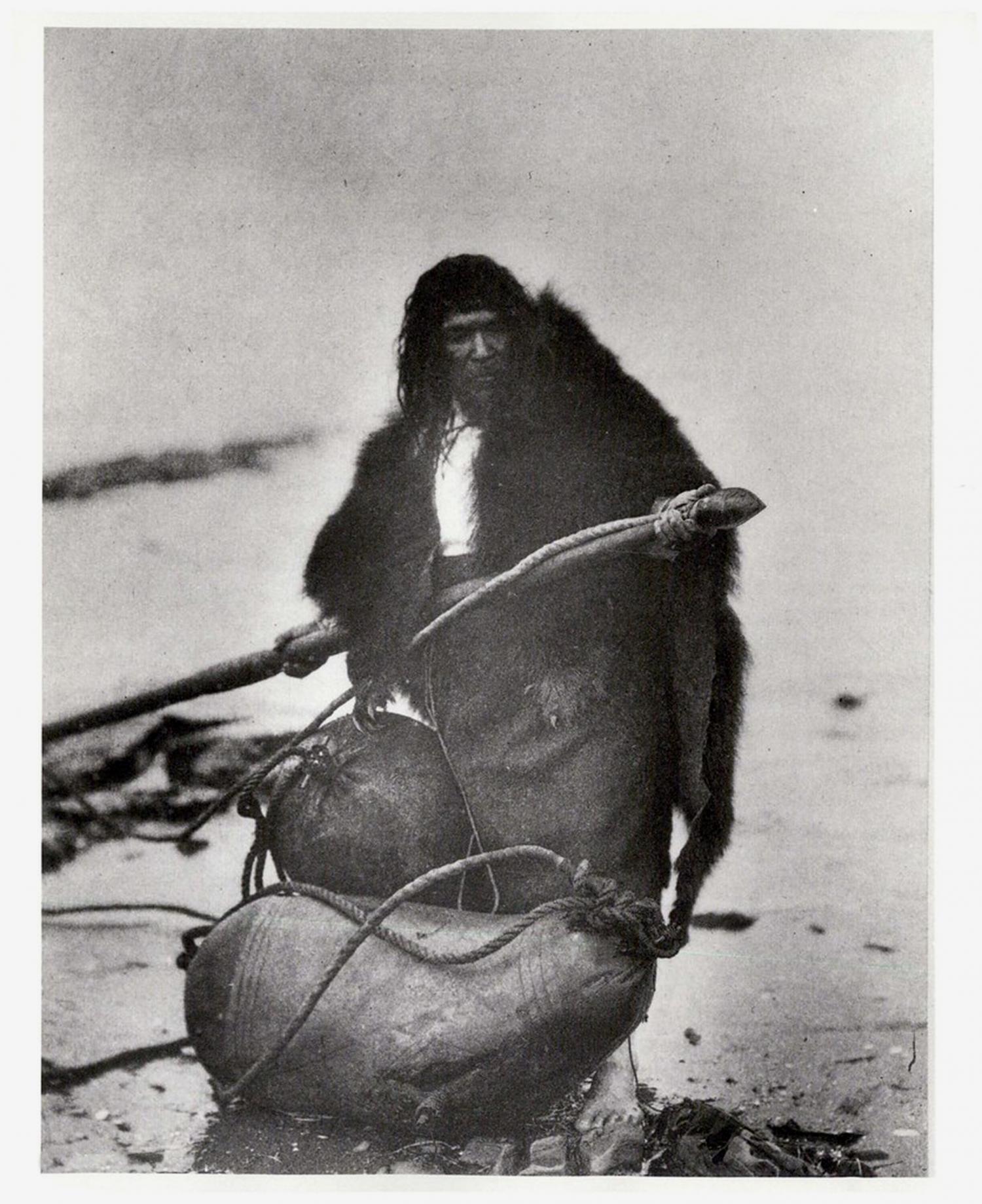 Indigenous whale hunter holding a torpedo.