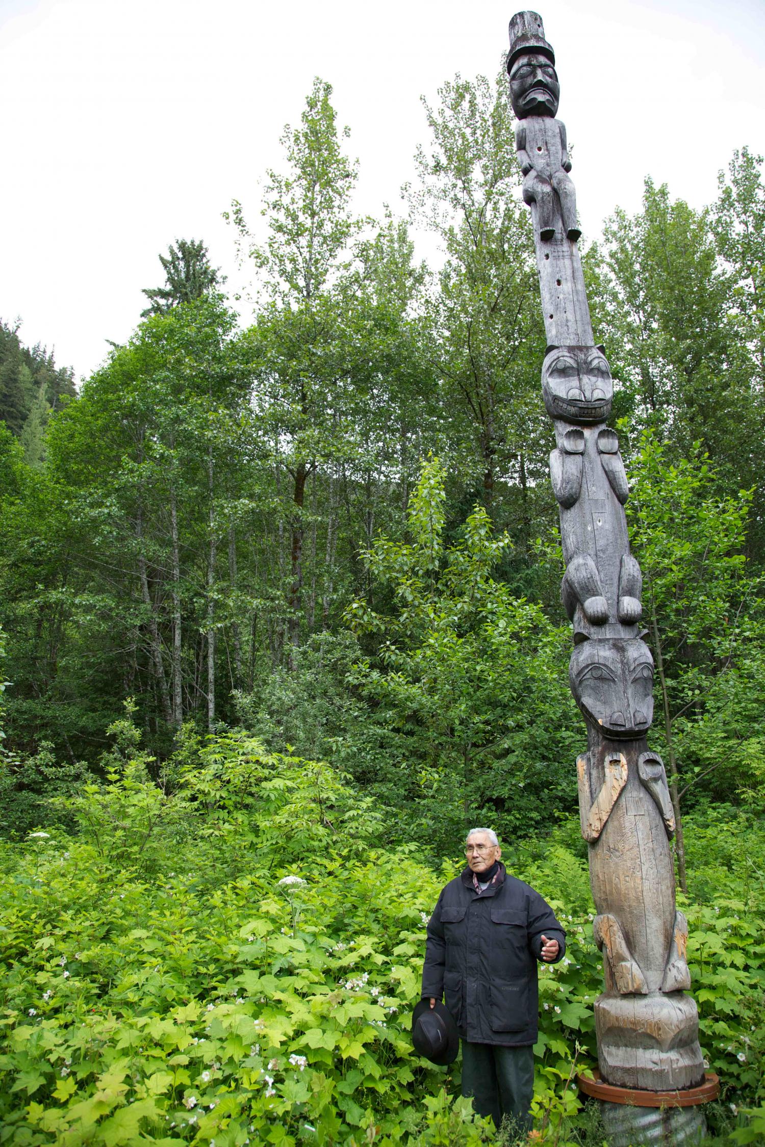 Cecil Paul speaks in front of the G’psgolox totem pole.