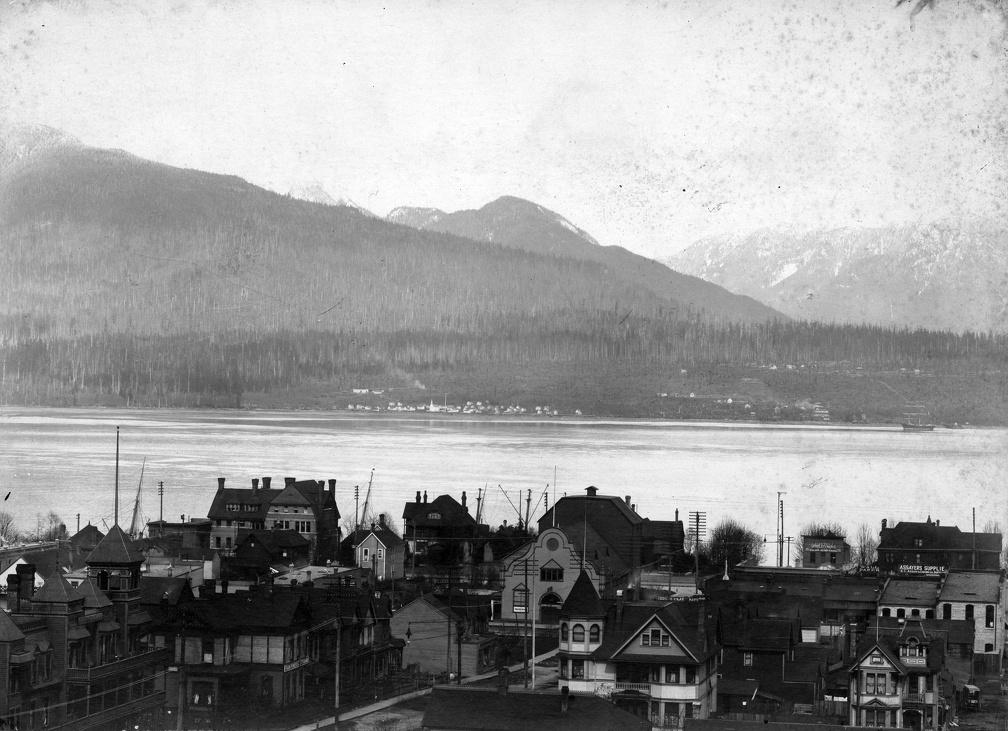 1903, [View from Dunsmuir Street and Granville Street showing the] business district in early days: Badminton Hotel, the Y.W.C.A., the Theatre Royal, the Vancouver Club and other buildings and the "Mission" and North Vancouver Indian Reserve in BG