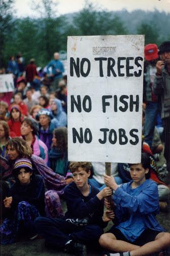 Young protestors with sign saying "NO TREES NO FISH NO JOBS"