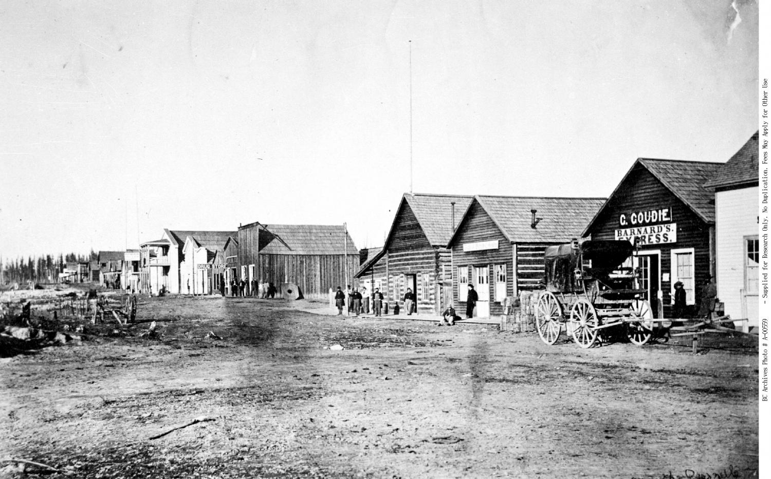 Quesnel ca. 1865: businesses, some people buggy without horse.