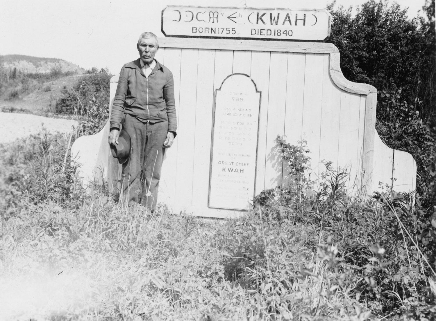 The grave of Chief Kw’eh, with Chief Louis Billy Prince, his grandson standing beside the tomb.